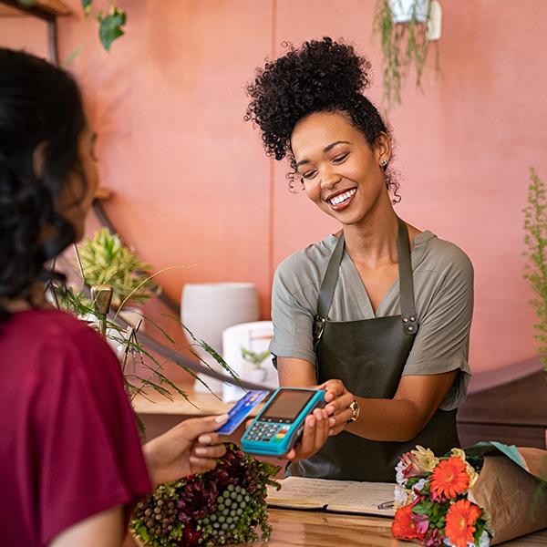 Florist shop assistant serving a customer.