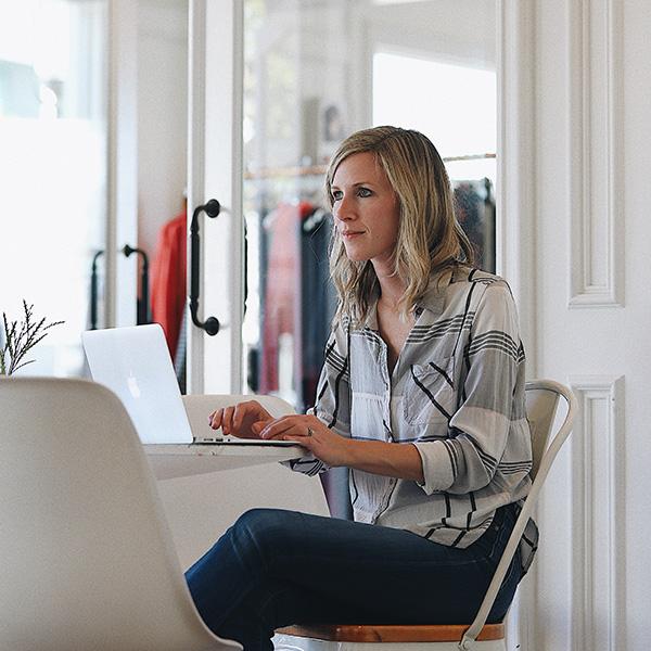 Woman sat at her desk working on a laptop